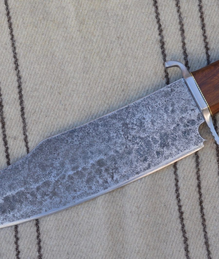 Hand forged bowie-style camp knife with wood handle and leather sheath