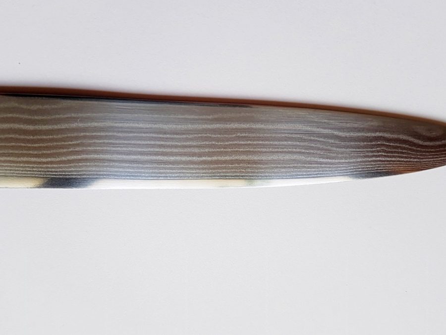 Close-up of a Damascus kitchen knife blade with fine wavy pattern